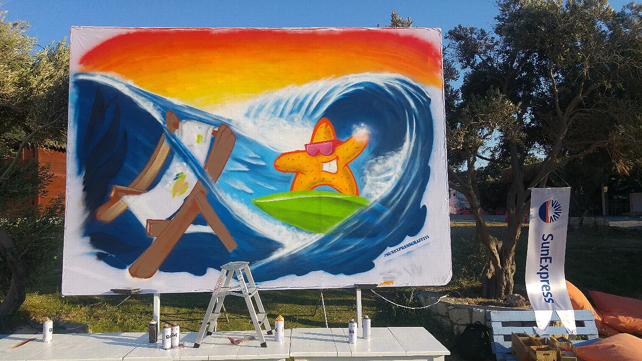 The process of creating a graffiti artwork on a billboard.