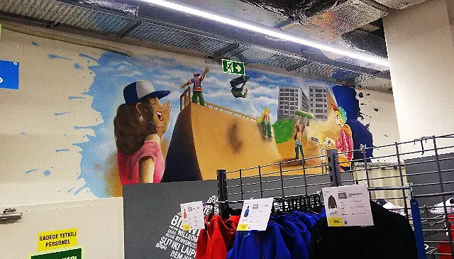 Skatepark mural featuring young people having fun.